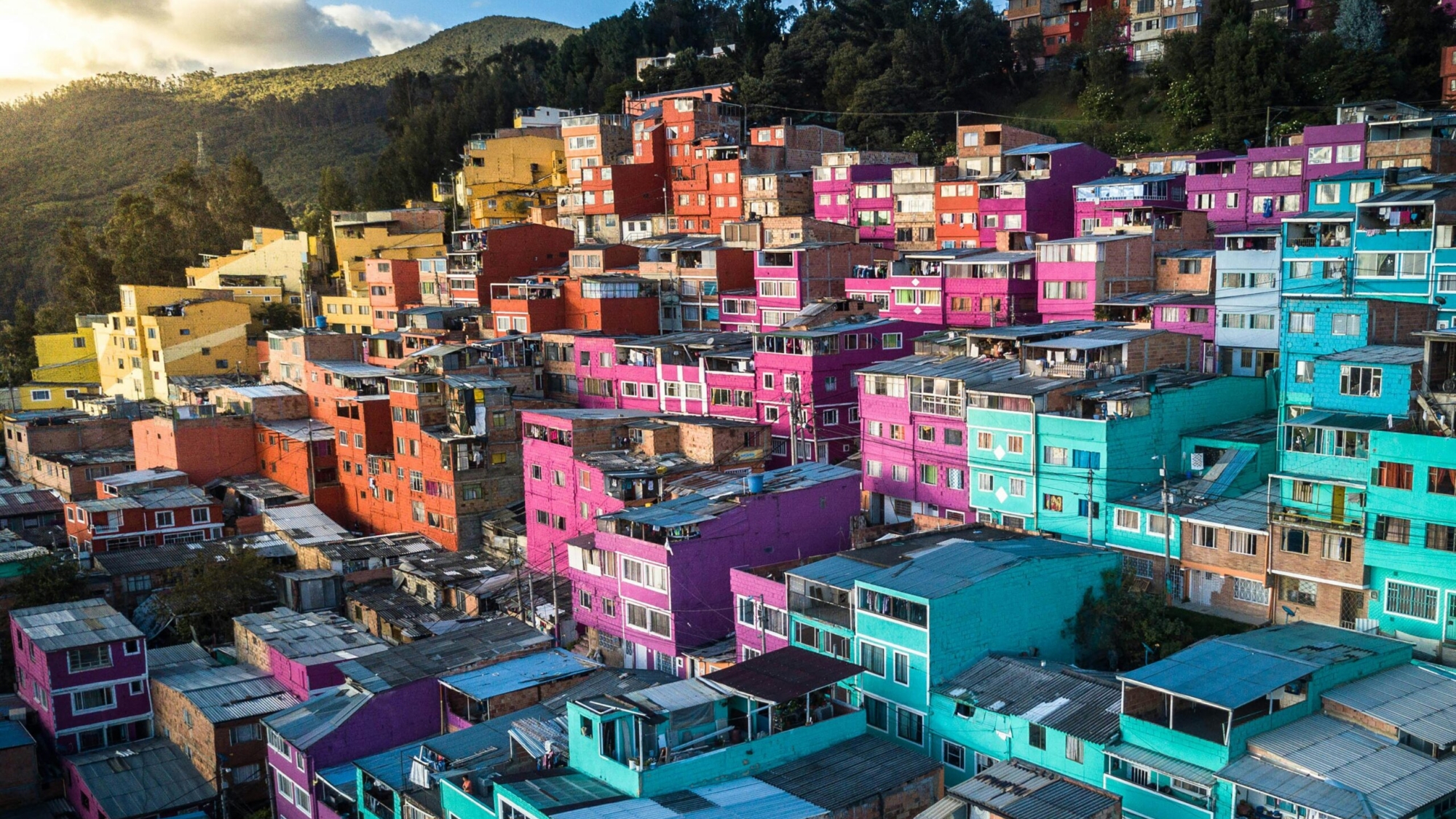 Aerial view of vibrant, colorful houses on a hillside in Bogotá, Colombia.